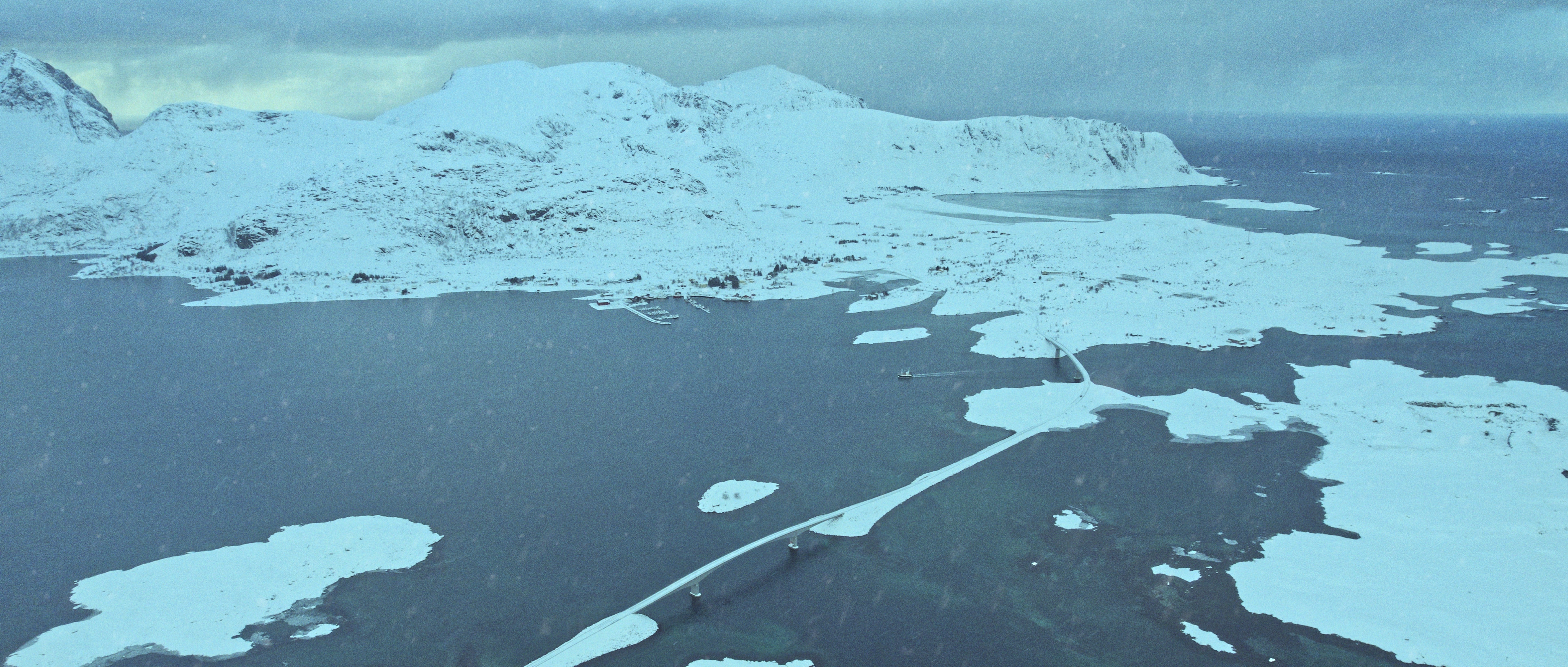 A snow-covered bridge crossing the sea between the Lofoten Islands